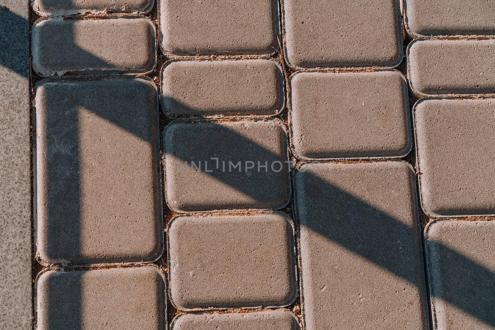 The surface is paved with road tiles of different sizes (multi format). The uneven (melange) color of the tile makes it look like a natural stone. Specially prepared background for seamless shading. by Matiunina