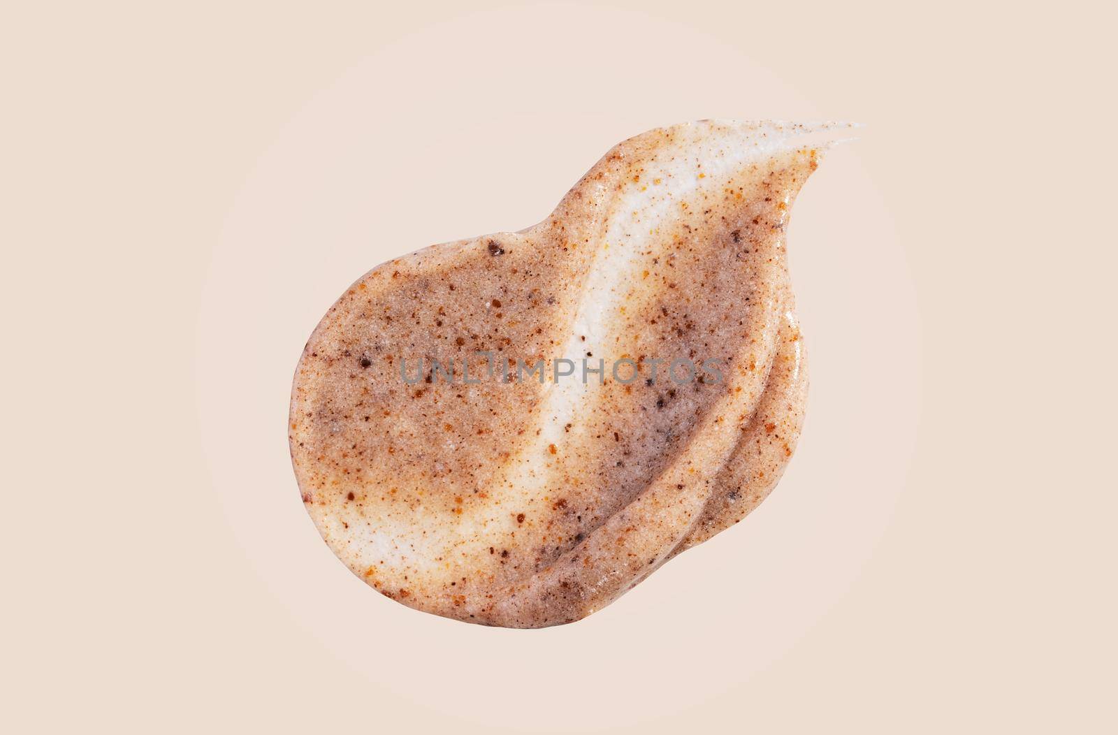 Scrub smear swatch isolated on beige background. Peeling cream smudge with exfoliating particles. Cosmetic skincare product with abrasive particle sample, gentle nude scrub texture isolate.