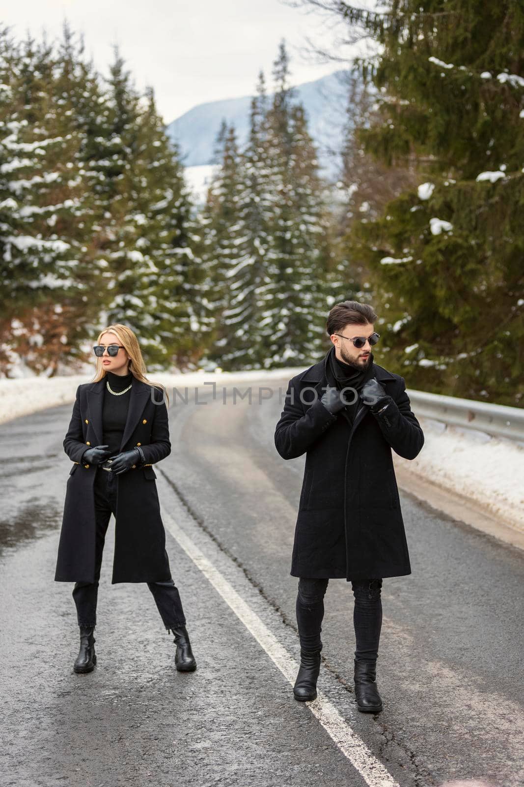 couple walking along the car road in the woods