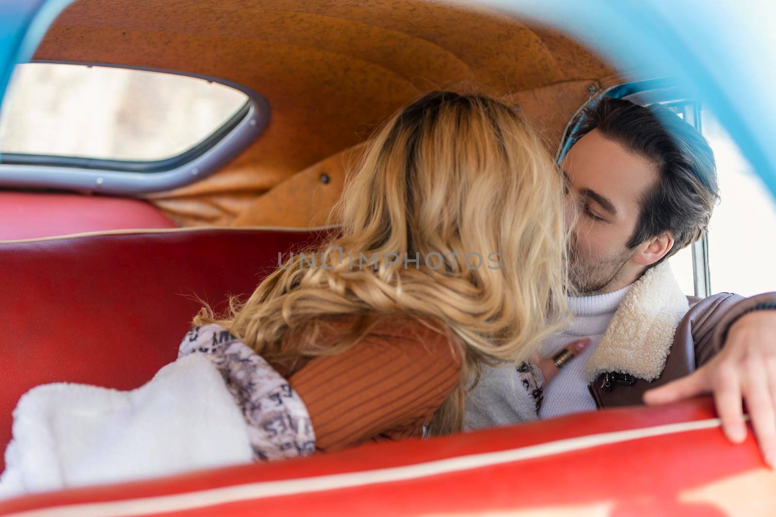 beautiful couple sitting in the back seat of a car