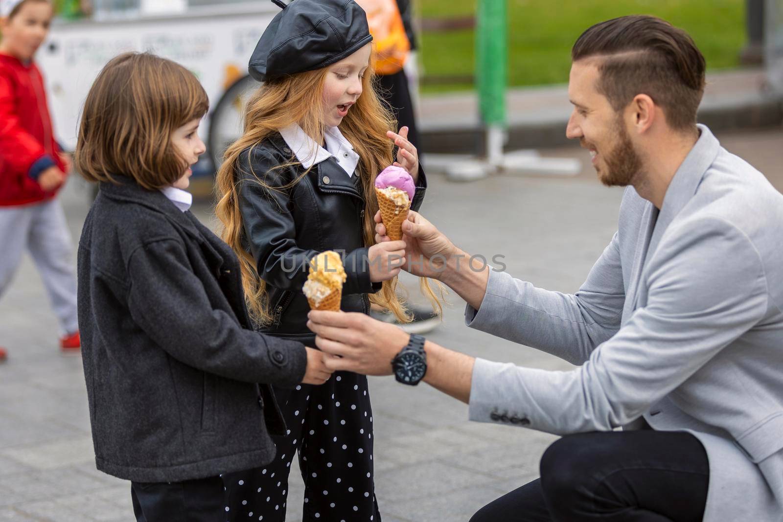 Man gives ice cream to children on the street