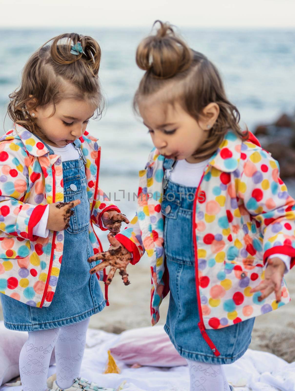 children eat chocolate covered cake with their hands