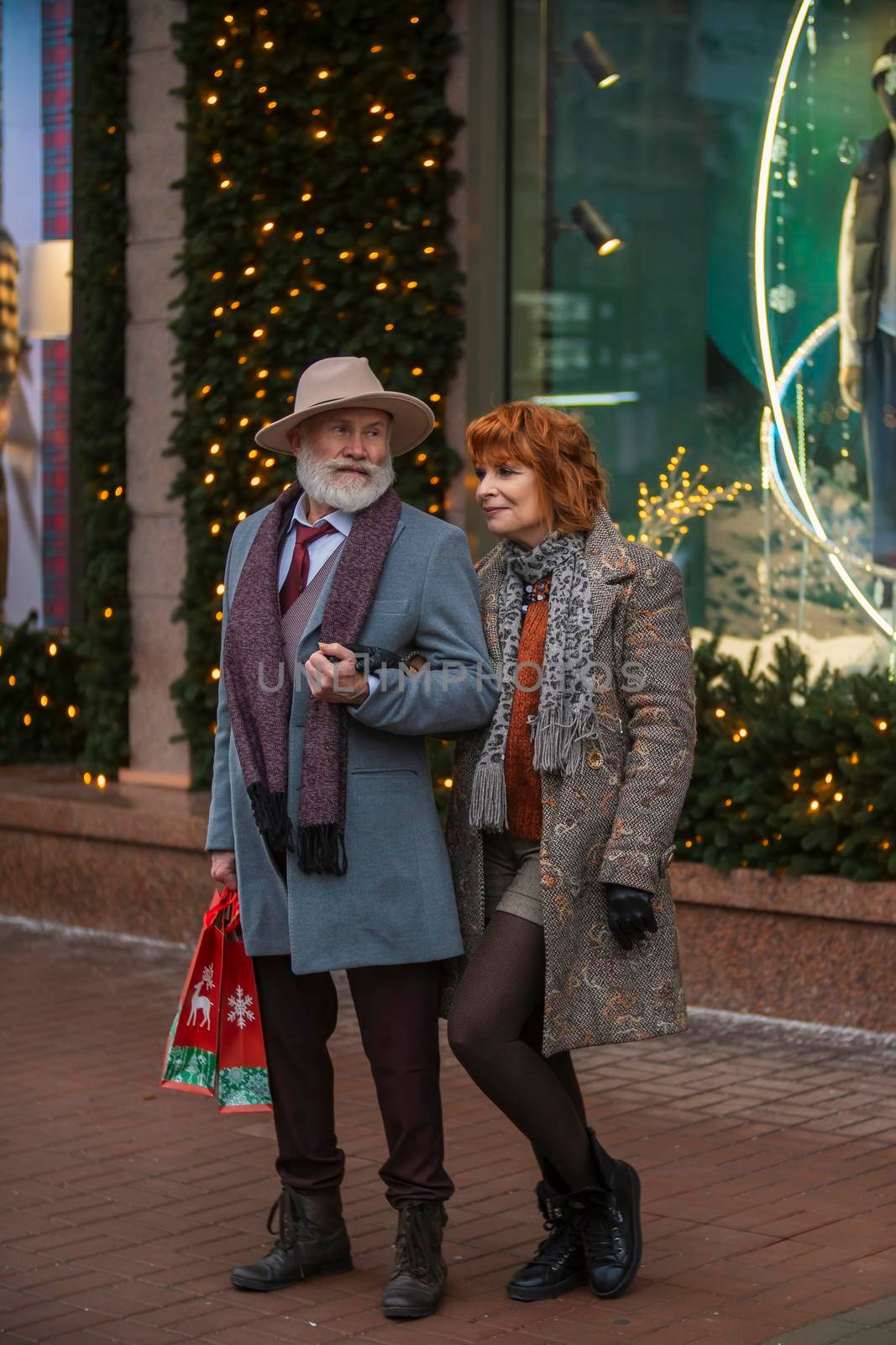 elderly couple on the background of a shop window