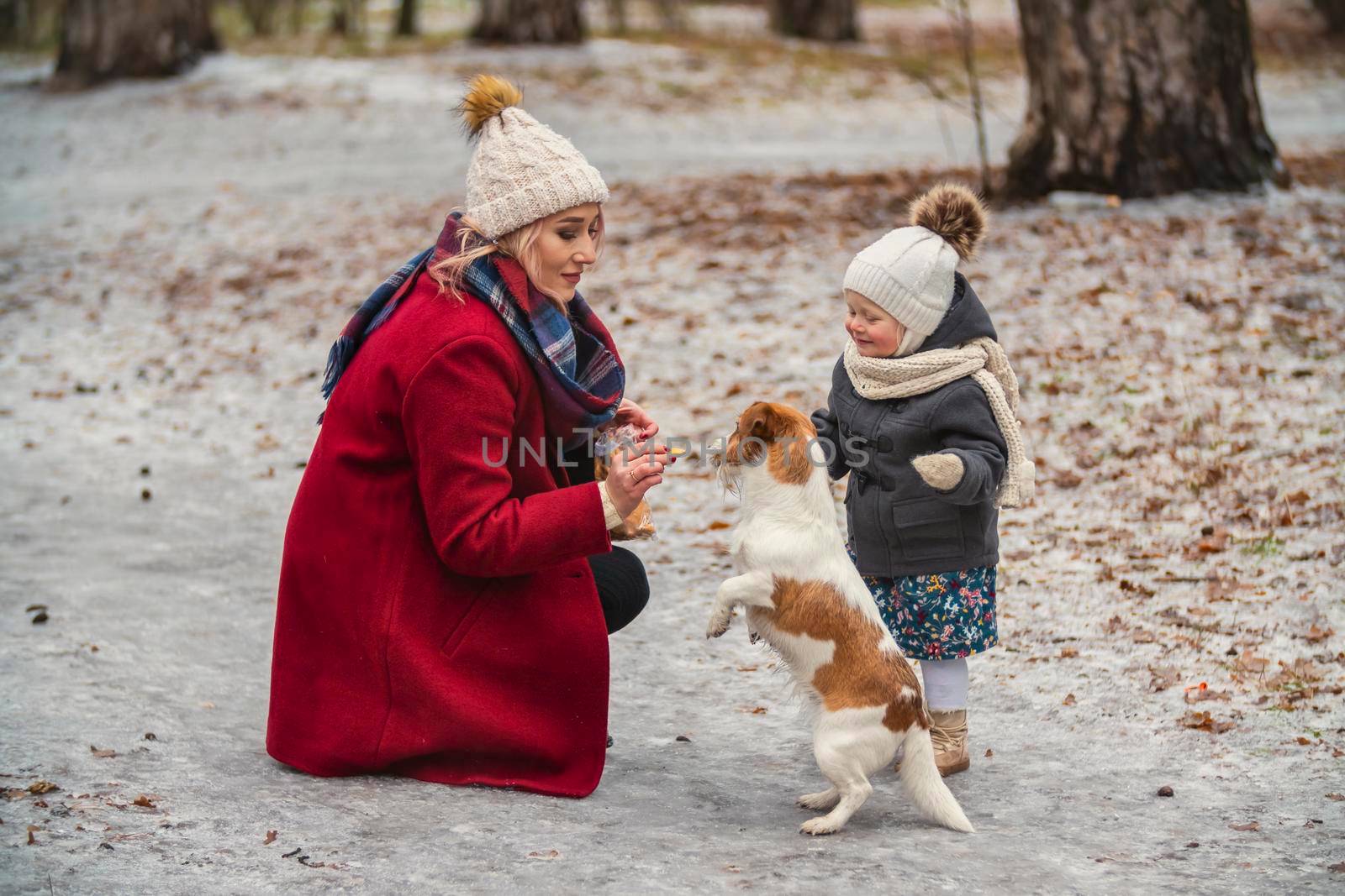 mom with daughter and dog in winter park