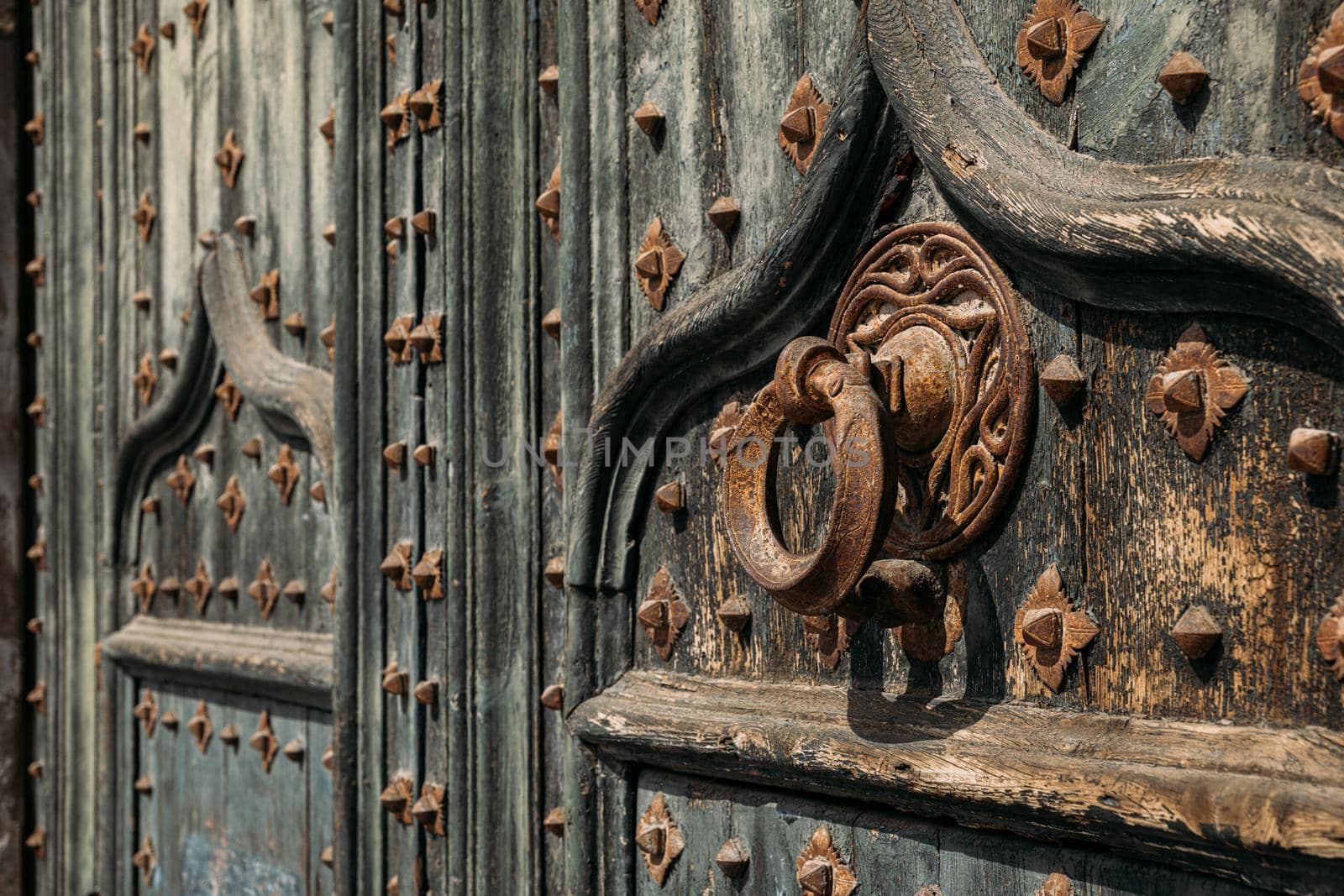 Details of portal to Cathedral. Metal knocker on wrought iron reinforced old wooden doors to Girona Cathedral, Spain by apavlin