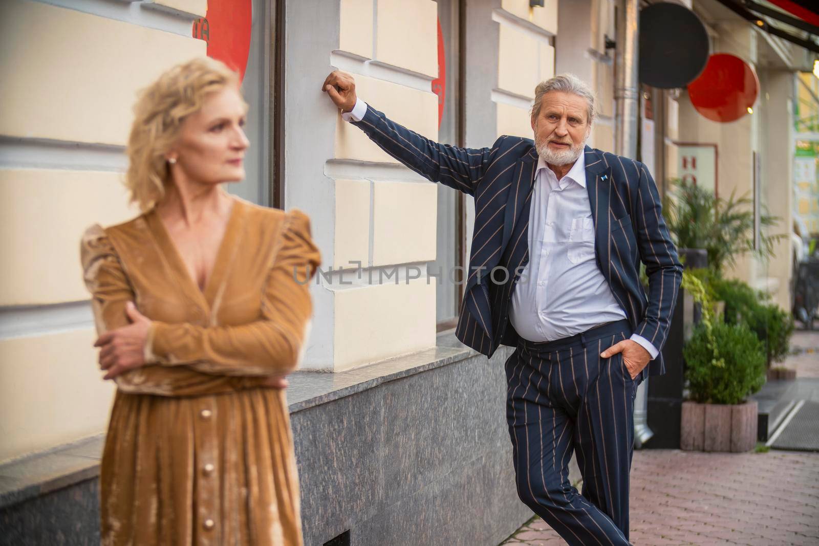 aged couple walking in the city center