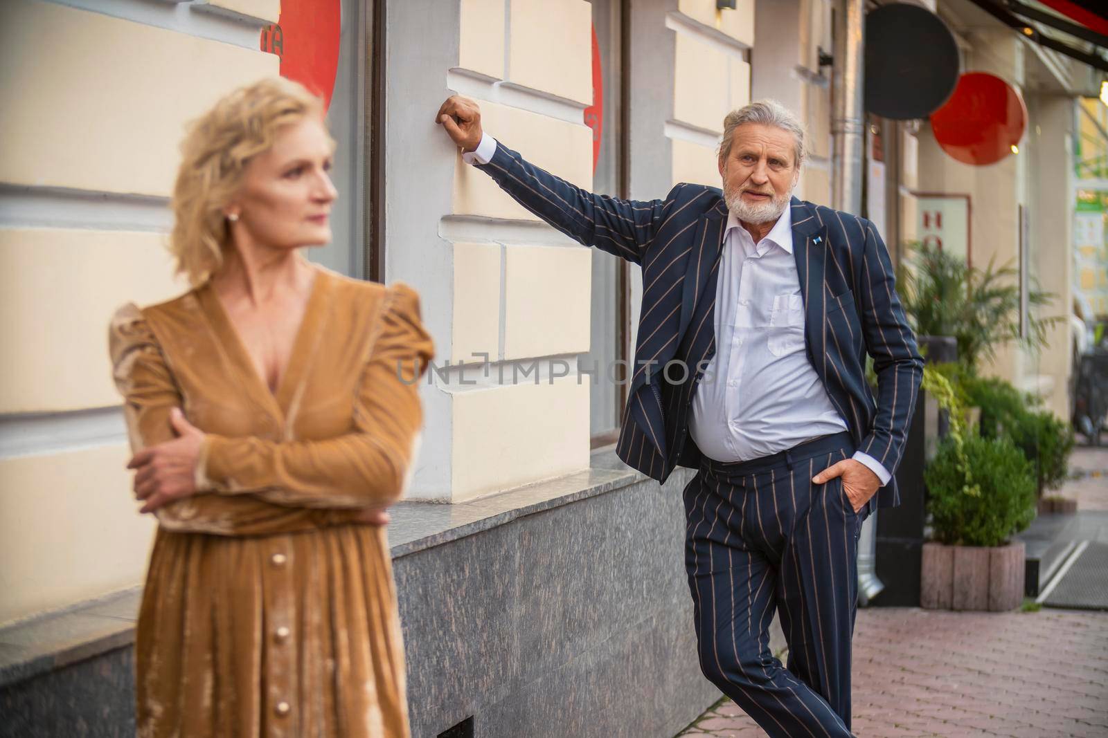 aged couple walking in the city by zokov