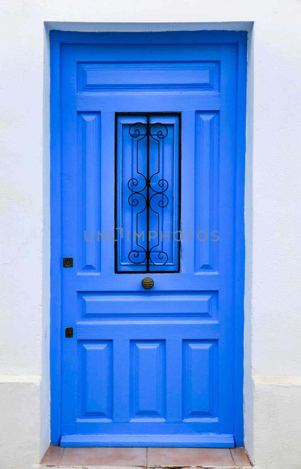 Blue wooden door and whitewashed facade in Altea by soniabonet