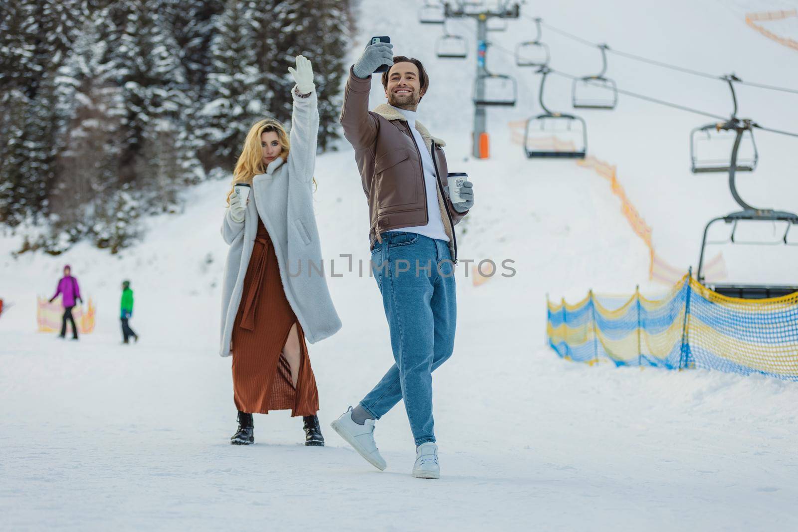 couple taking a selfie in winter by zokov