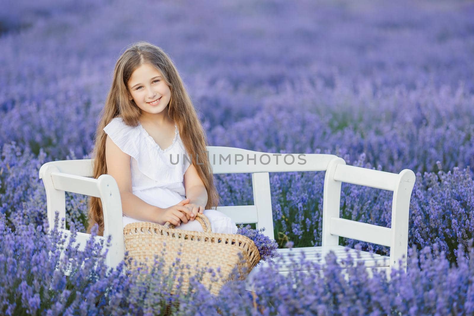 portrait of a girl with a bouquet on a lavender field