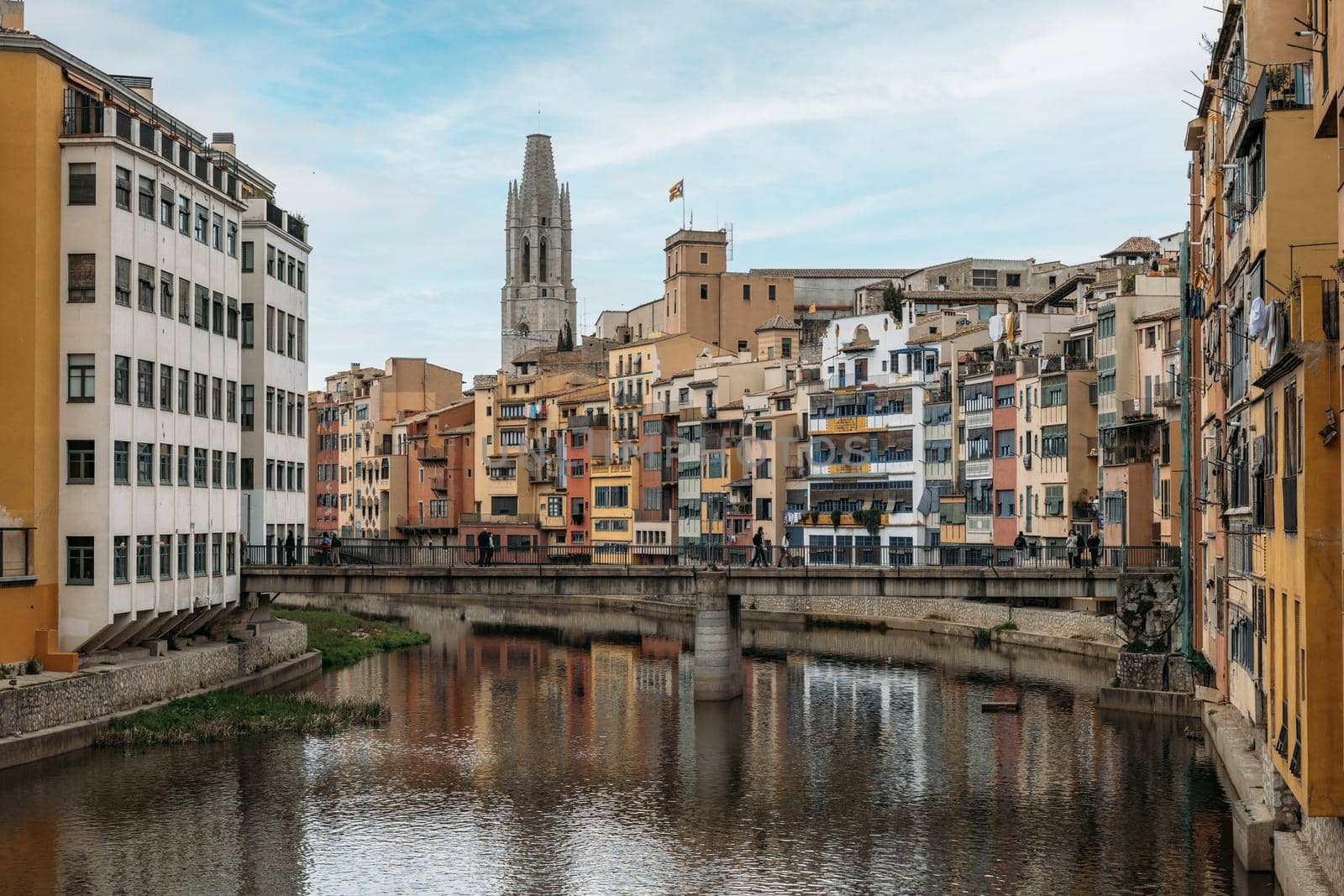 Colourful old town on river Onyar of Girona and view to cathedral on cloudy day, Catalonia, Spain.