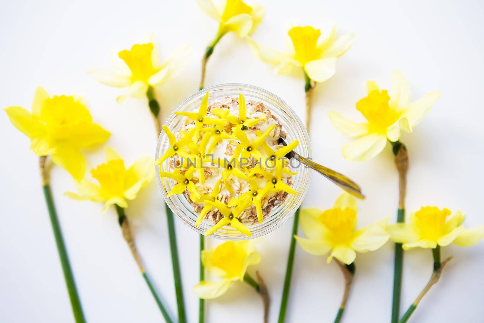 A big bouquet of daffodils and beautiful yellow flowers on the table by sfinks