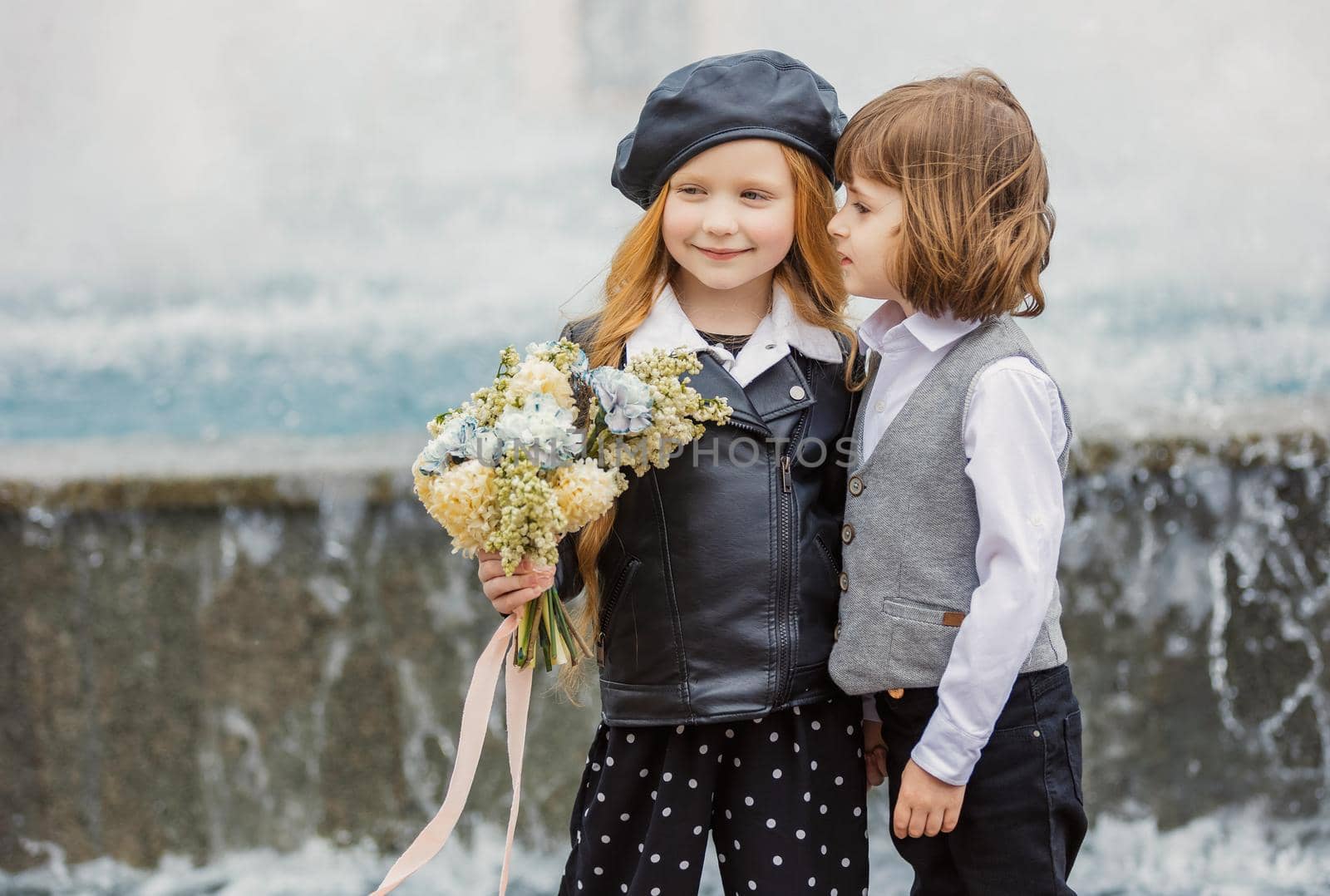 a couple of children on the background of the fountain