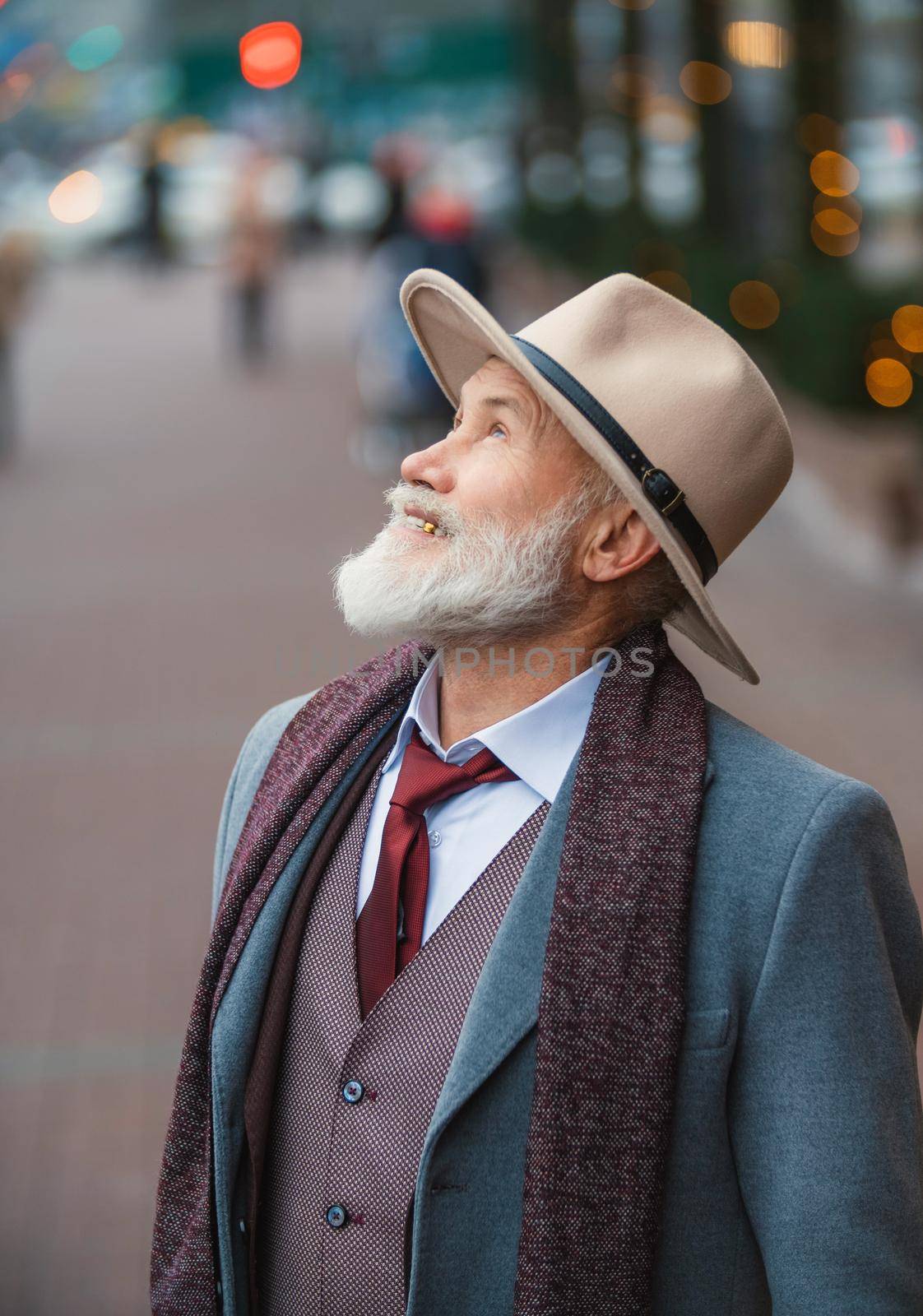 portrait of a bearded man aged on the street in the city