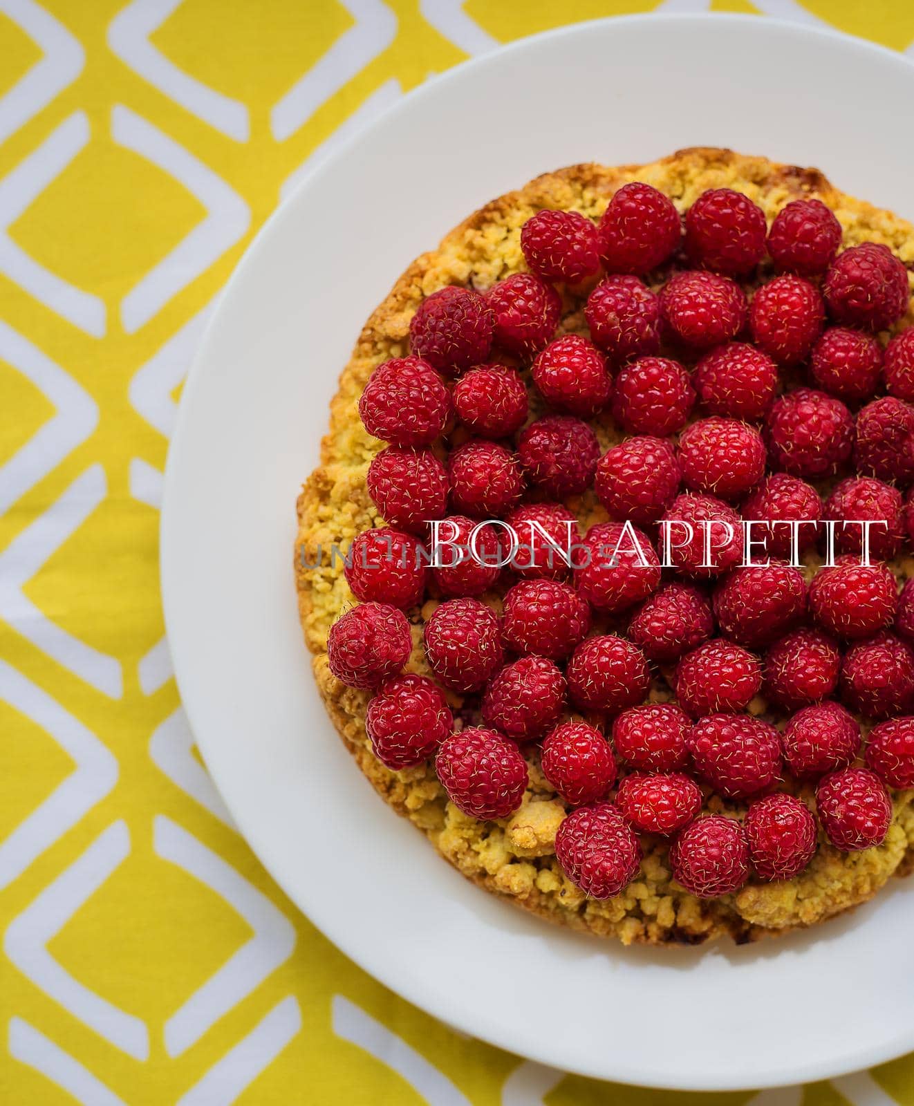 bright raspberry cake on yellow napkin with the words delicious.