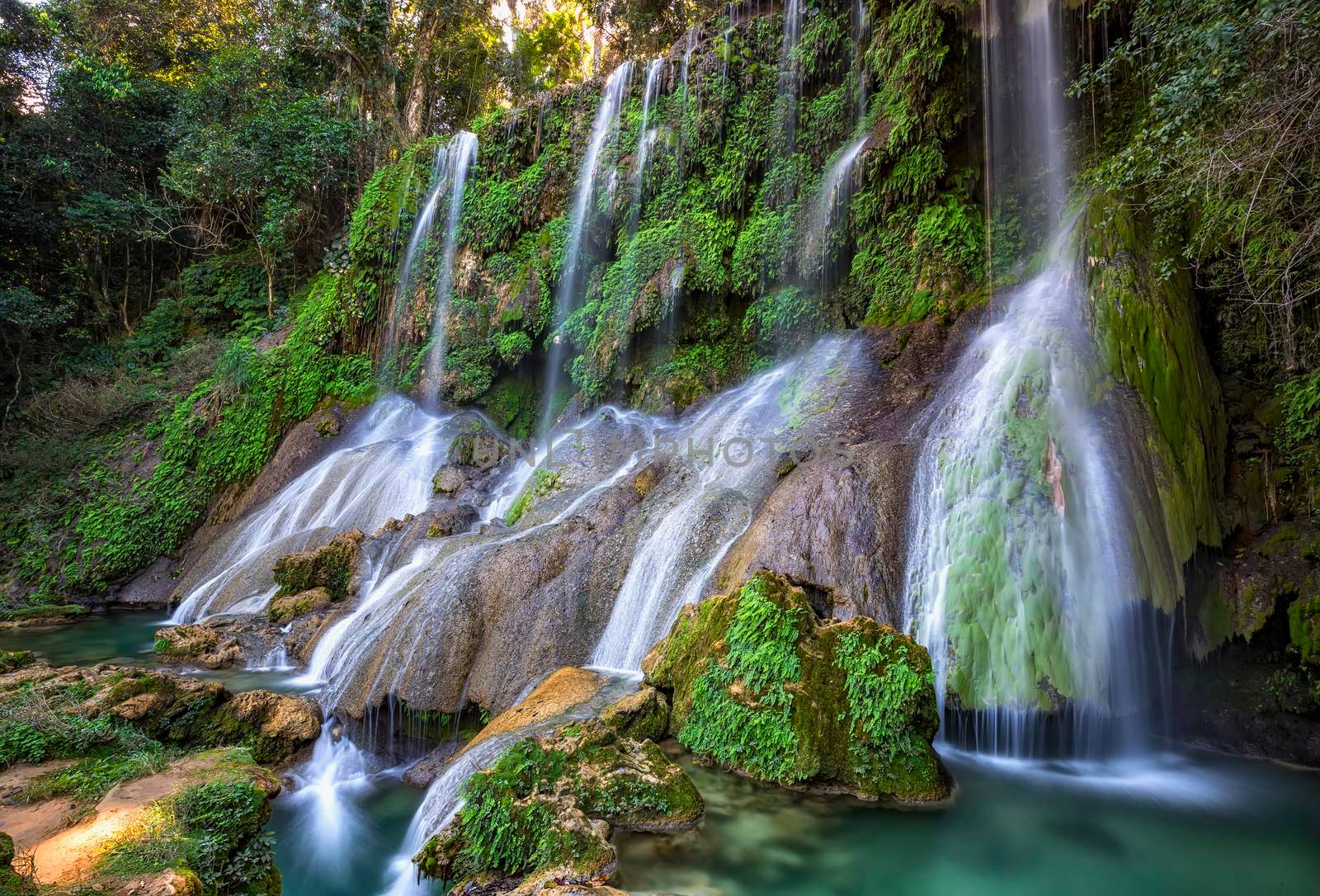 El Nicho Waterfalls in Cuba. El Nicho is located inside the Gran Parque Natural Topes de Collantes a forested park that extends across the Sierra Escambray mountain range in central Cuba.