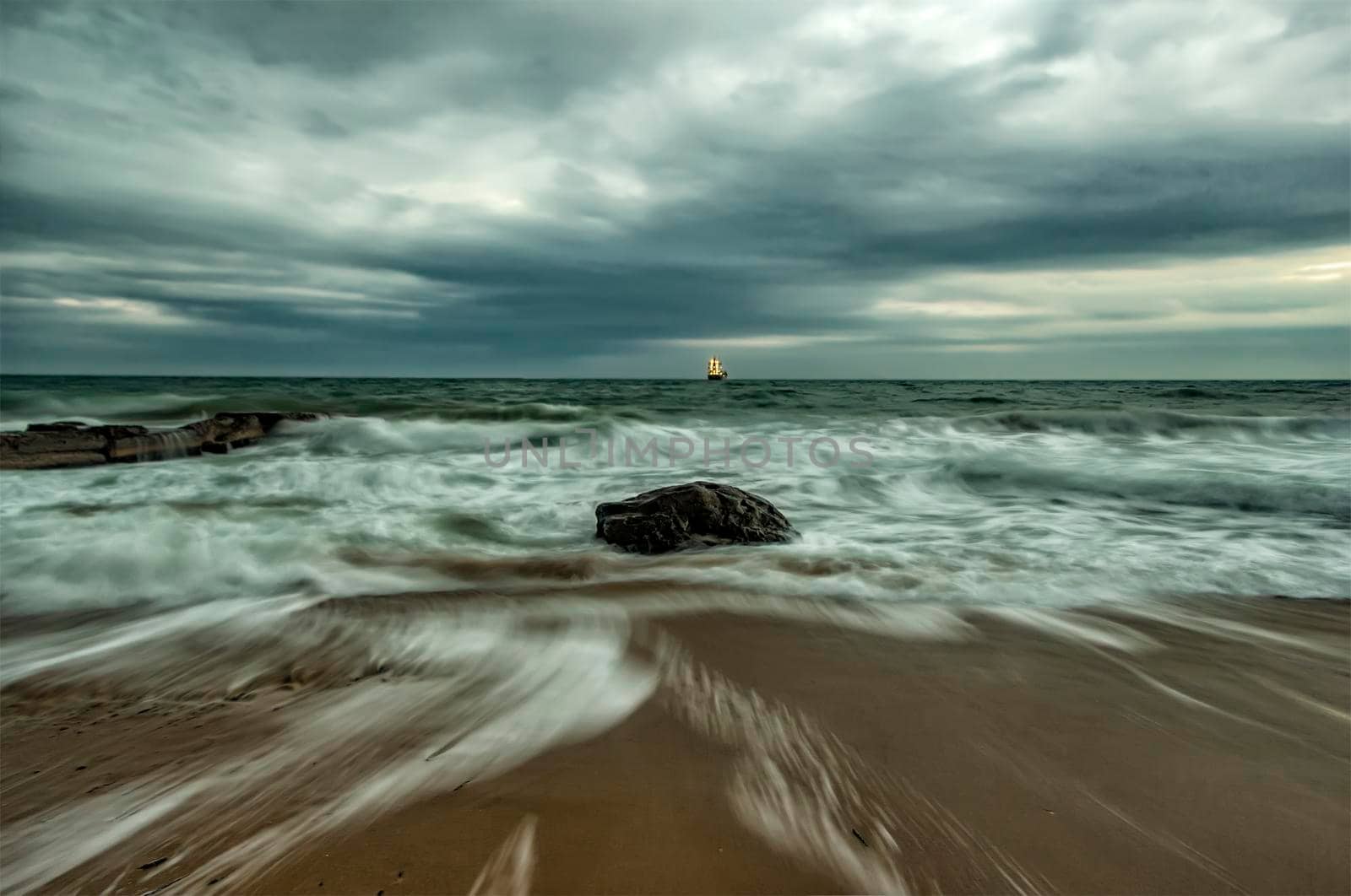 Beauty cloudy, long exposure seascape with slow shutter and waves flowing out.