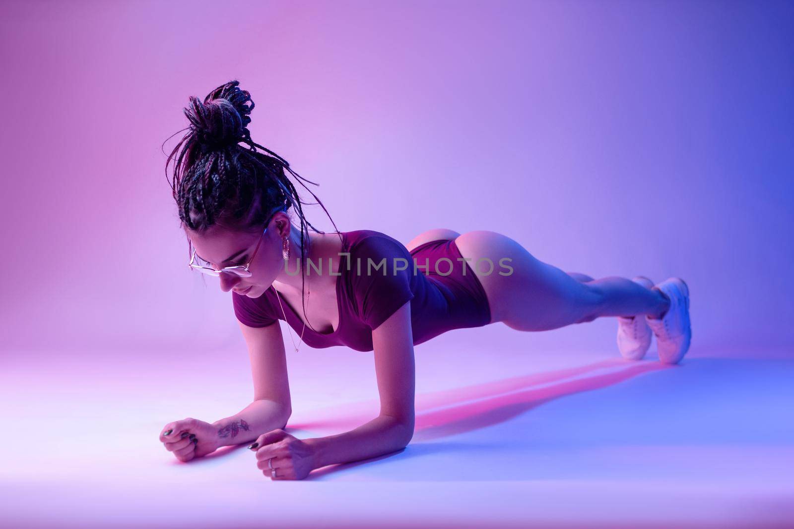 the Slim fitness young girl doing planking exercise indoors at home gymnastics.