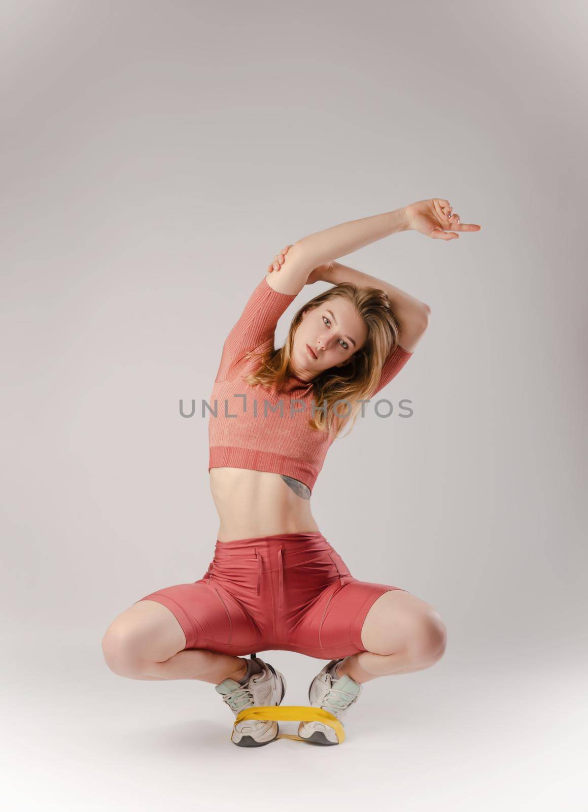 the athletic girl posing in the Studio on a white background