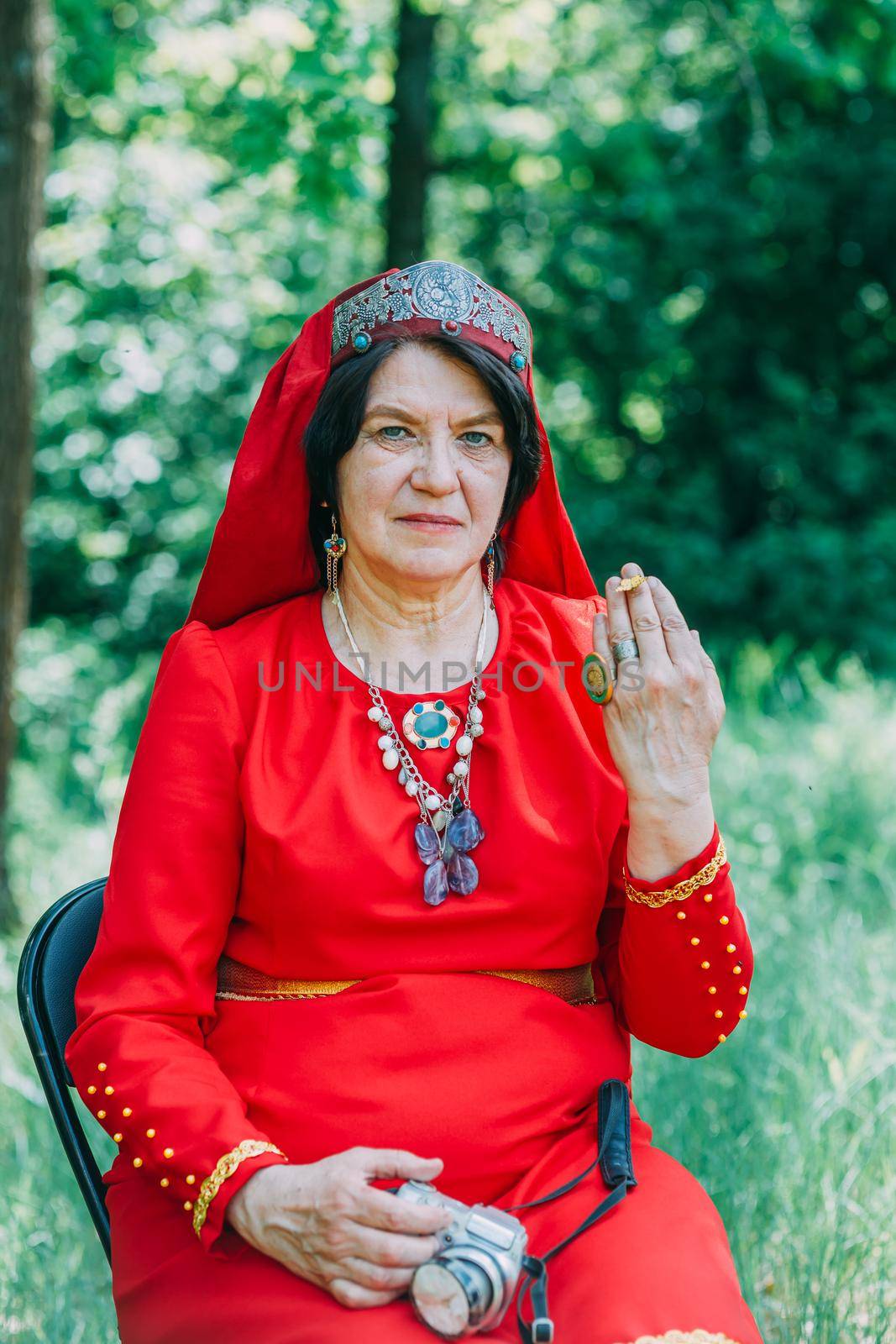 the senior priestess with a butterfly on her fingers prepared for the rite of sacrifice. mystical pagan rite. pagans today. by mosfet_ua