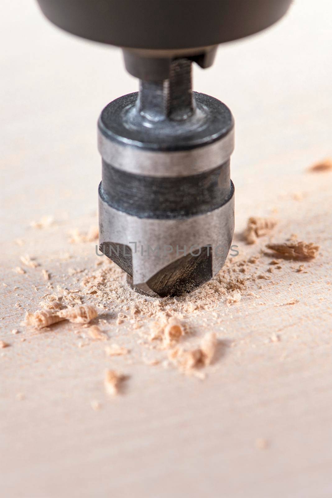 Countersink for deepening the self-tapping screw. A countersink drill makes a recess in a hole for a screw in a wooden board. by SERSOL