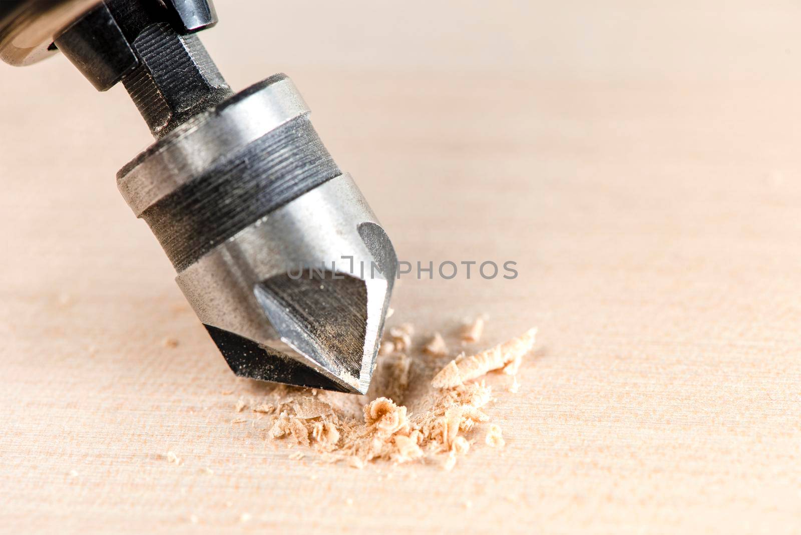 Countersink for deepening the self-tapping screw. A countersink drill makes a recess in a hole for a screw in a wooden board. by SERSOL