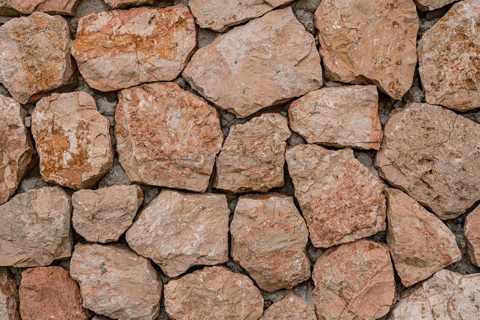 Marble bricks stone wall close-up . marble bricks texture of the walls. marble pattern of the brick wall. stone fence. by Matiunina