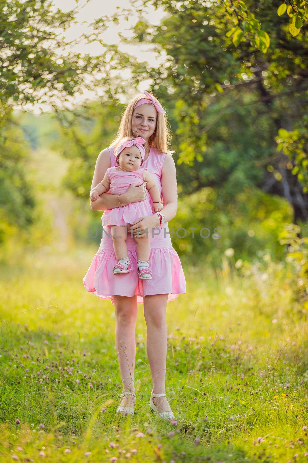 child in the arms of a mother who is in nature