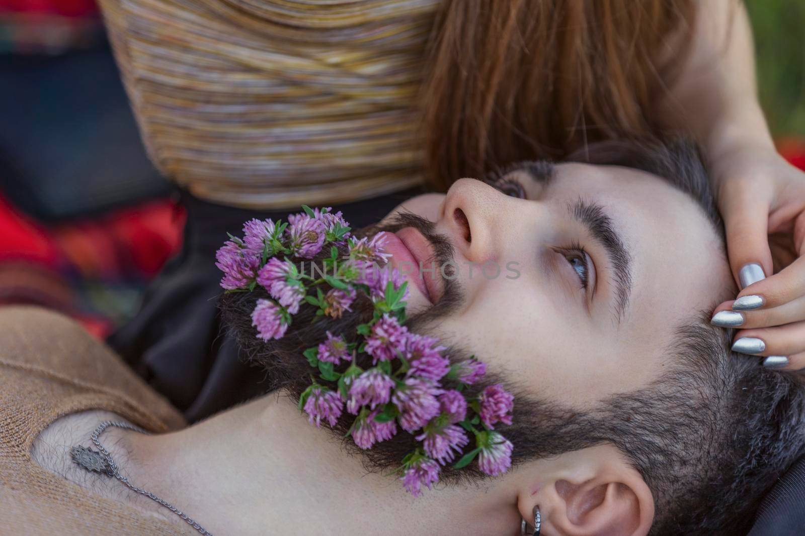man with flowers in his beard