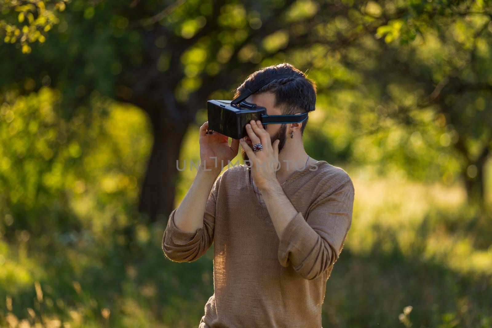 man wearing virtual reality glasses outdoors