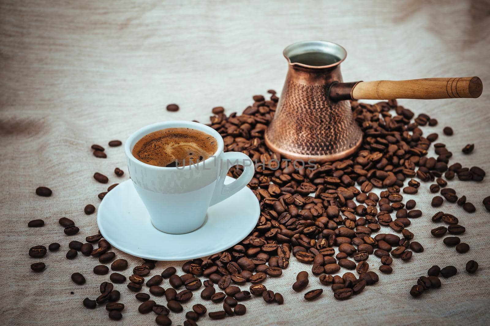 Coffee turk and cup of coffee on burlap background. coffee beans isolated on white background. roasted coffee beans by Andrii_Ko