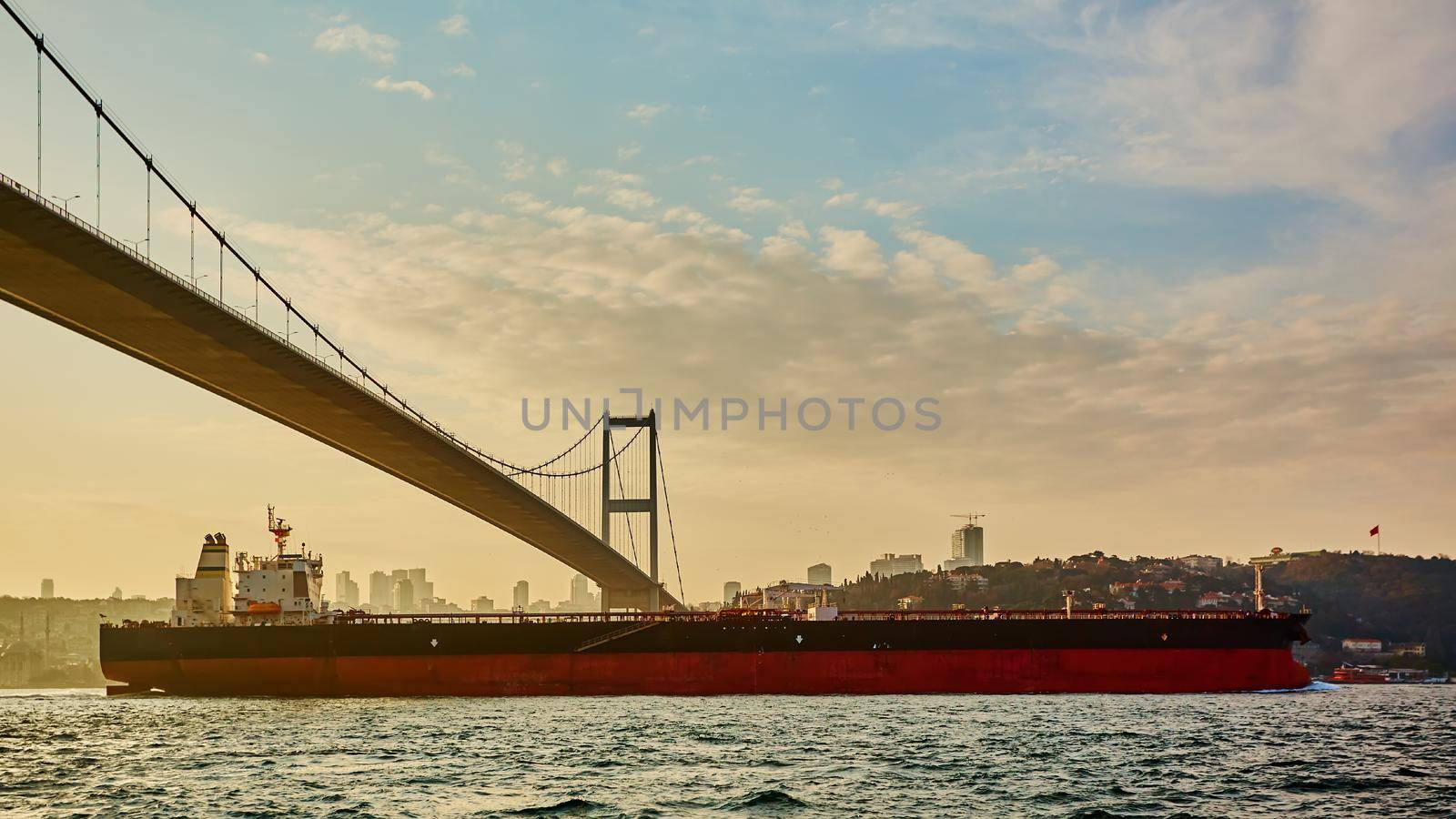 Cargo ship tanker in Bosphorus Strait about to pass under Bosphorus bridge in Istanbul, Turkey