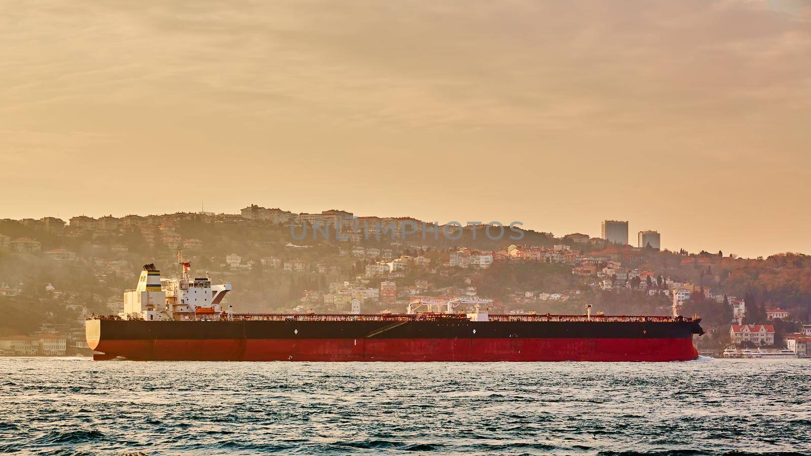 Cargo ship tanker in Bosphorus Strait about to pass under Bosphorus bridge in Istanbul, Turkey