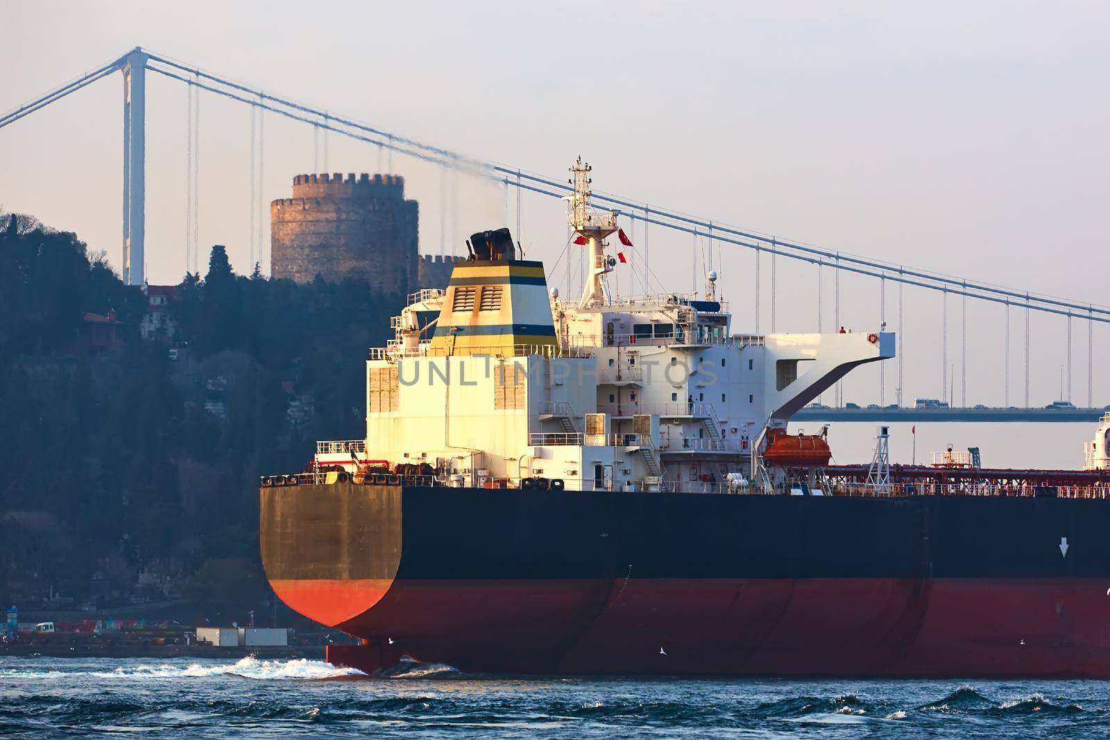 Cargo ship tanker in Bosphorus Strait about to pass under Bosphorus bridge in Istanbul, Turkey