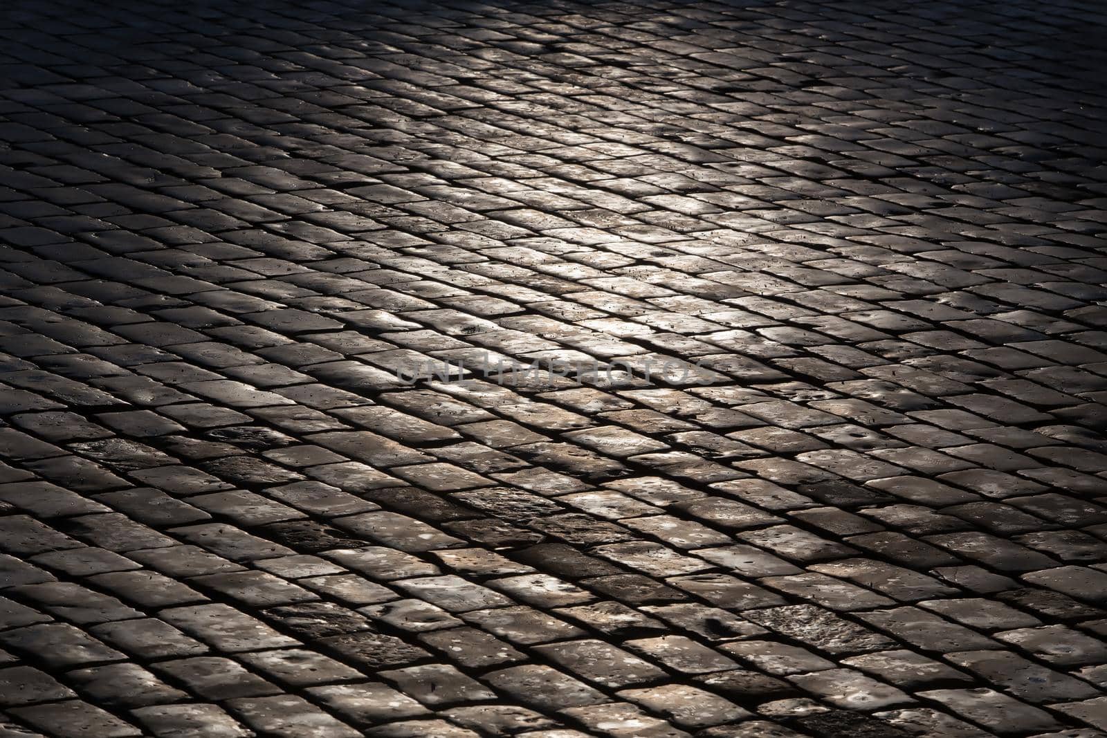 old stone granite pavement. Background close-up.