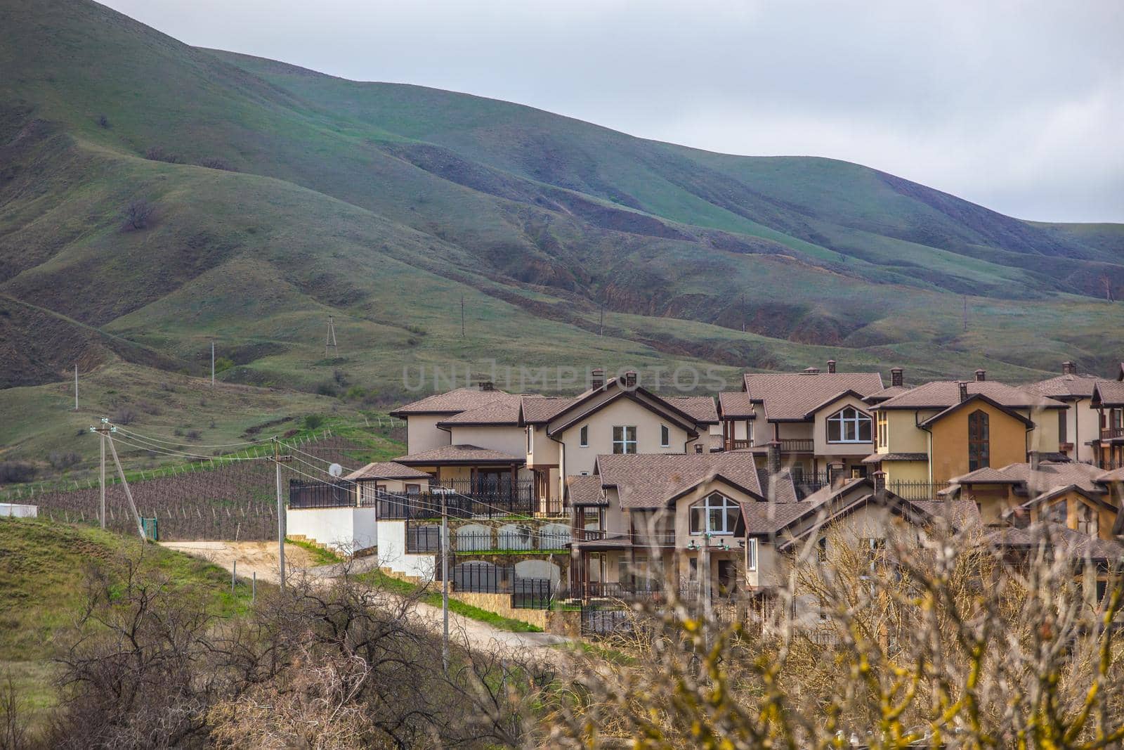 Cottage village in the valley near the mountain in spring