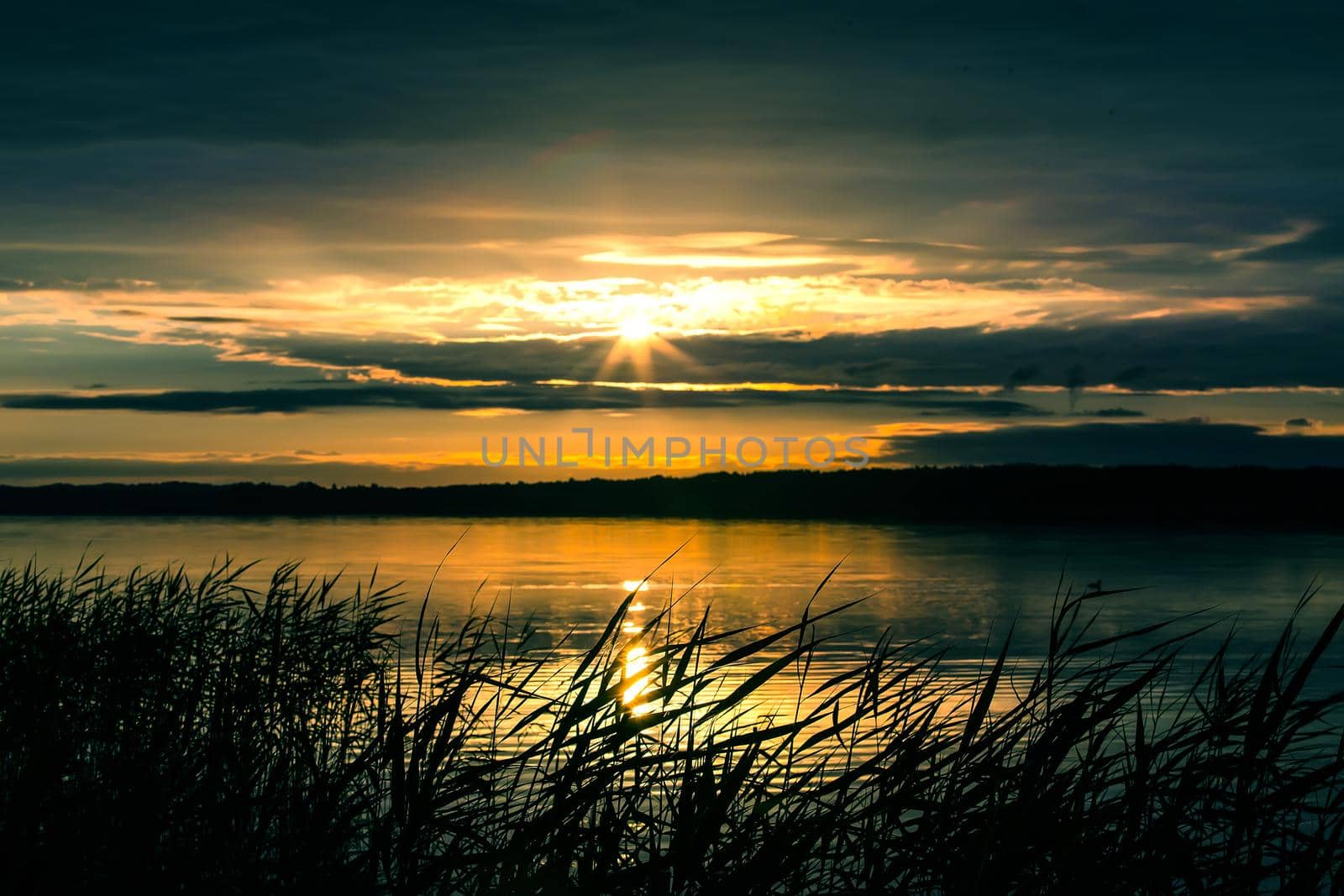beautiful sunrise over the lake in the cloudy sky
