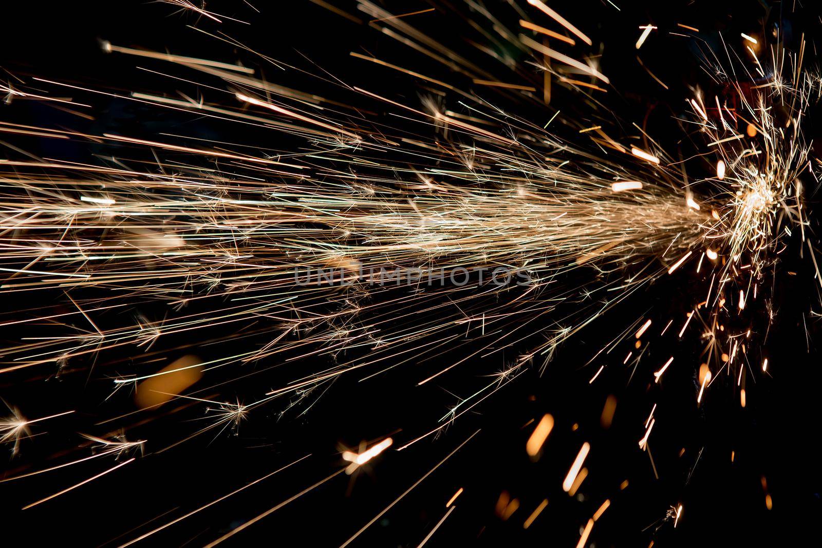 bright sparks of metal against dark background