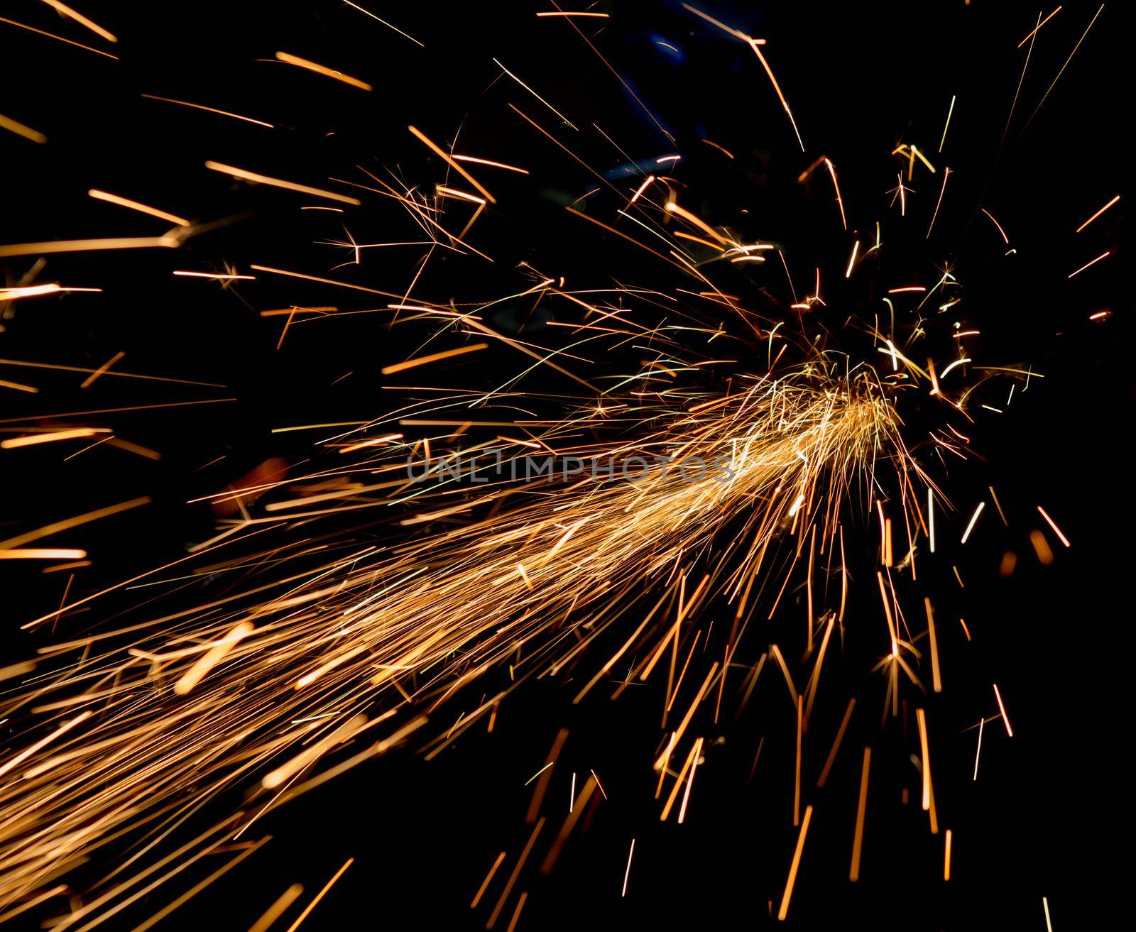bright sparks of metal against dark background