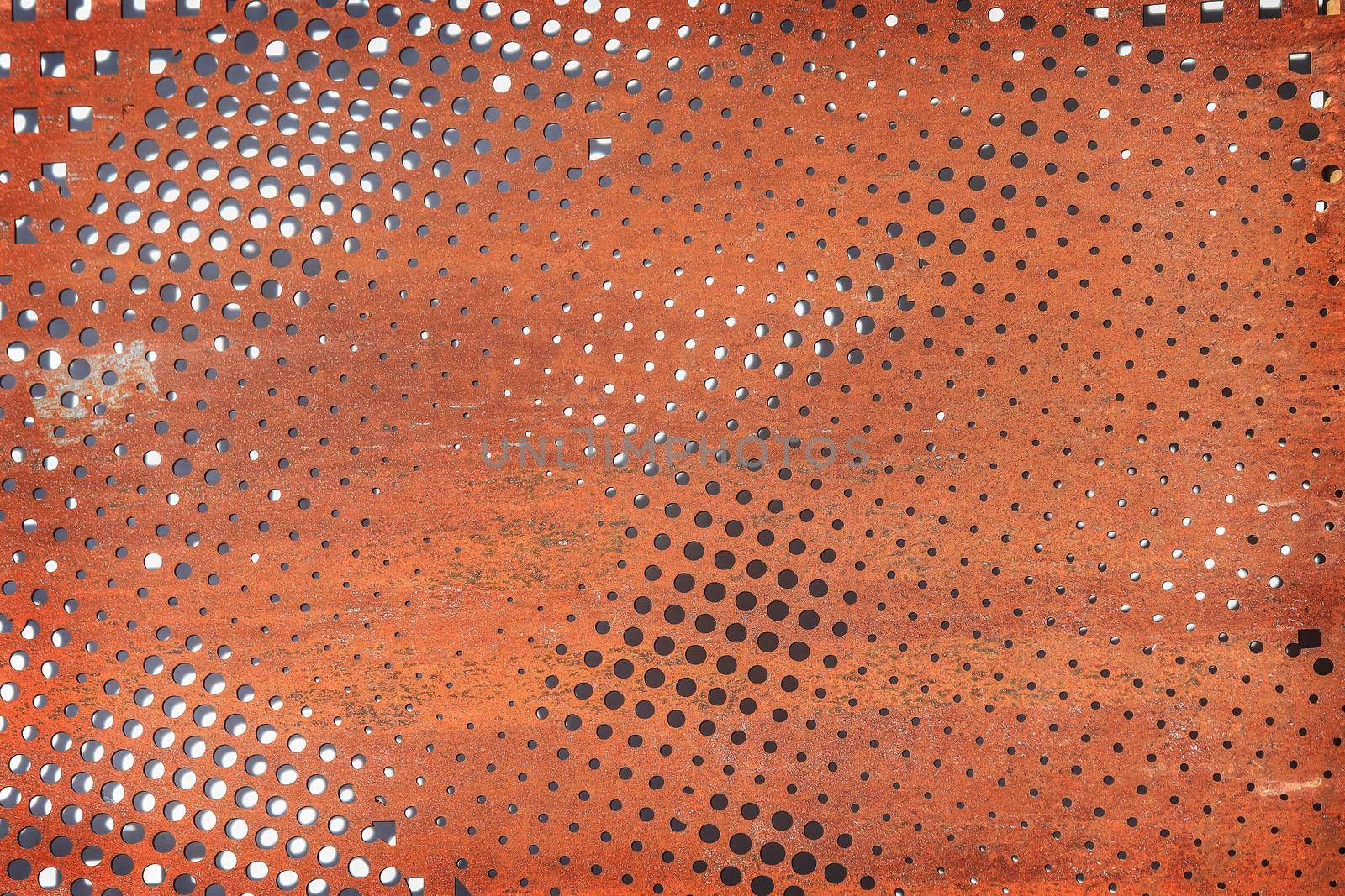 Rusty perforated metal surface. Background