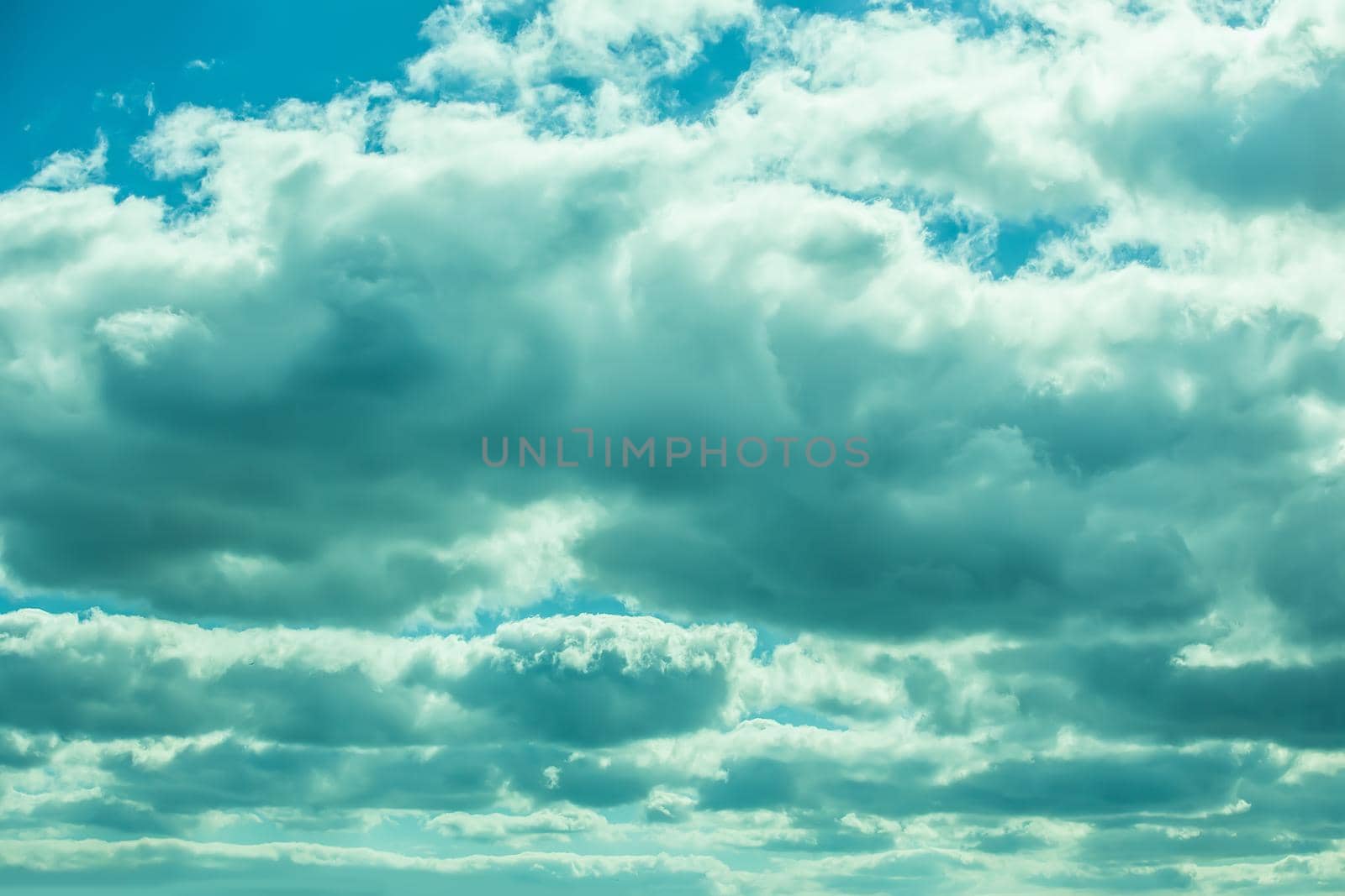 blue sky with clouds closing the sun