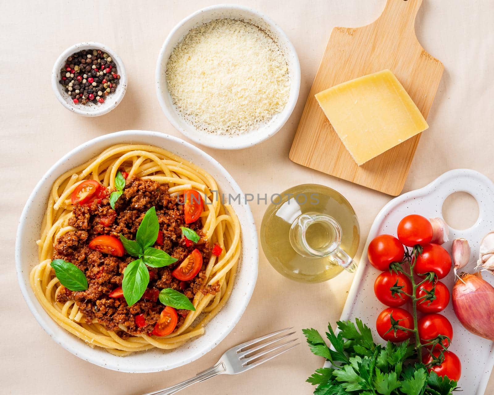 pasta bolognese with tomato sauce, ground minced beef, basil leaves on background by NataBene