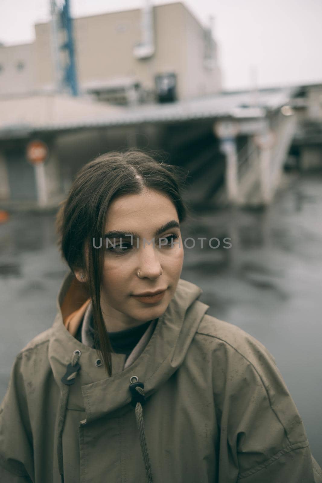 beautiful girl in a raincoat on street