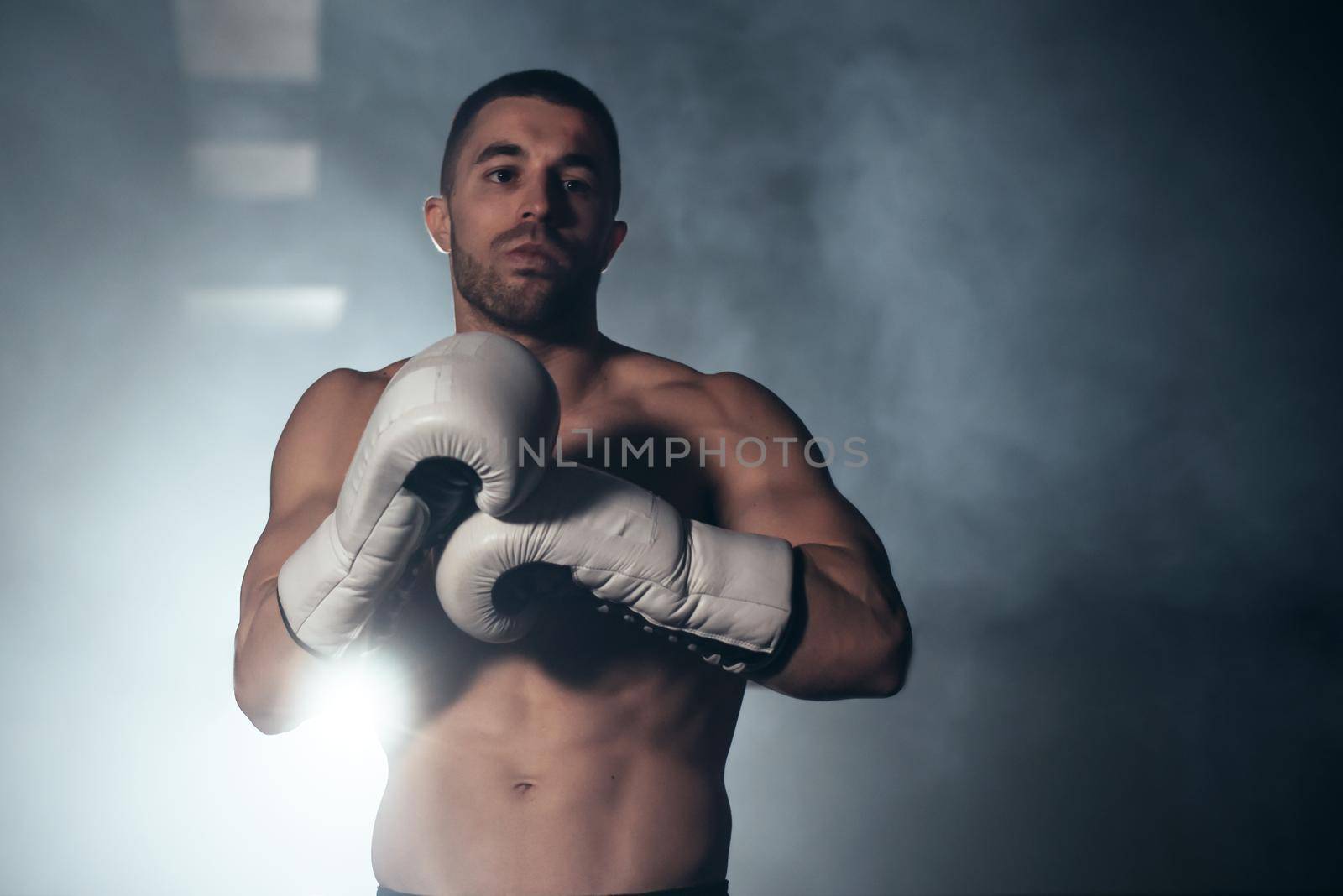 Confident boxer standing in pose, ready to fight. High quality photo