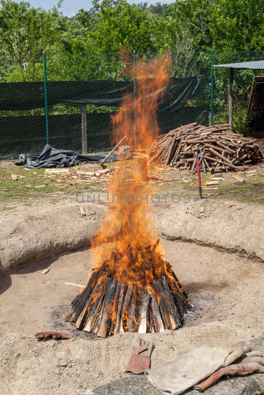 Preparation of the bonfire during the cooking process of the black clay of Gondar in Amarante, Portugal.