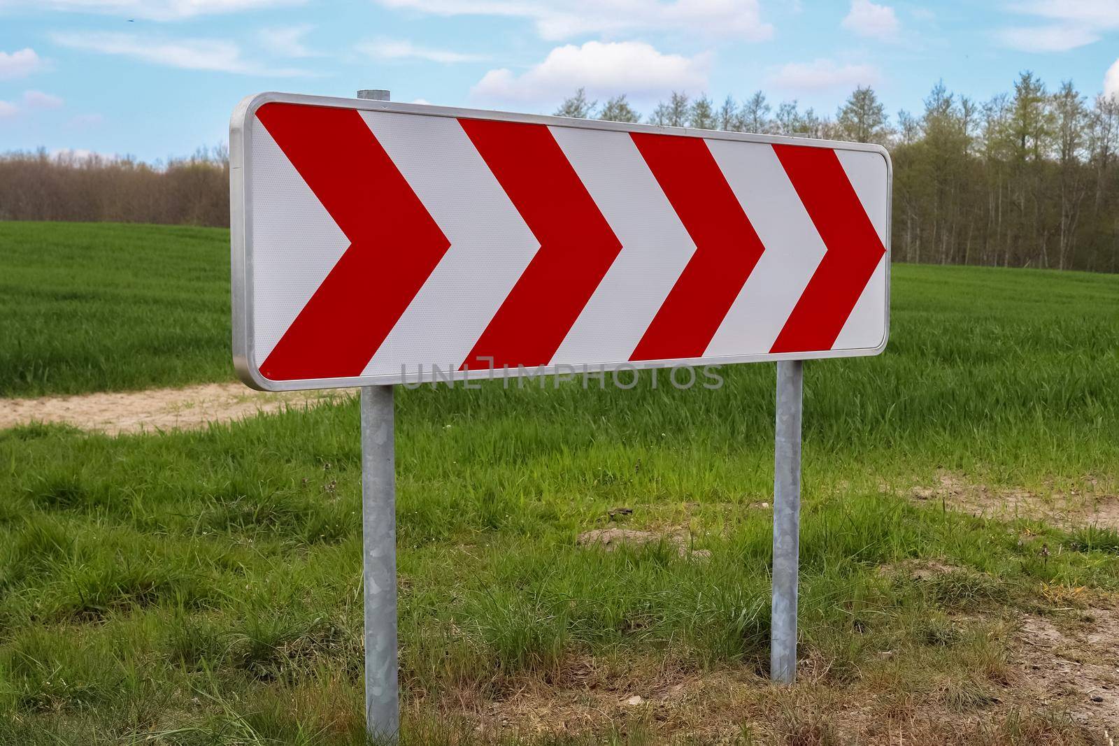 A large warning sign for a very sharp bend on a German country road