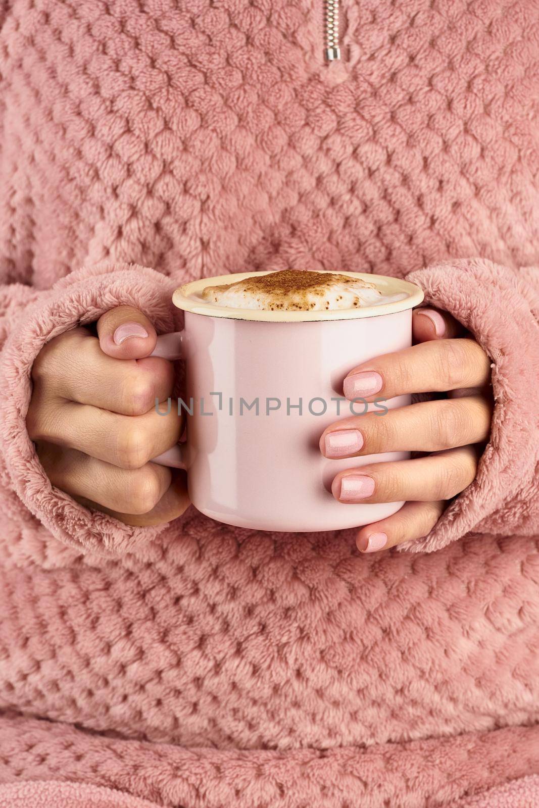 hands holding cup of chocolate, pink home cozy jacket, beautiful pink manicure, home style, autumn morning, close up, vertical