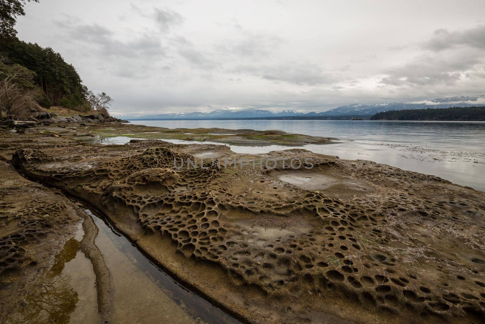 Nature landscape view on a rocky shore during a cloudy winter day by edb3_16