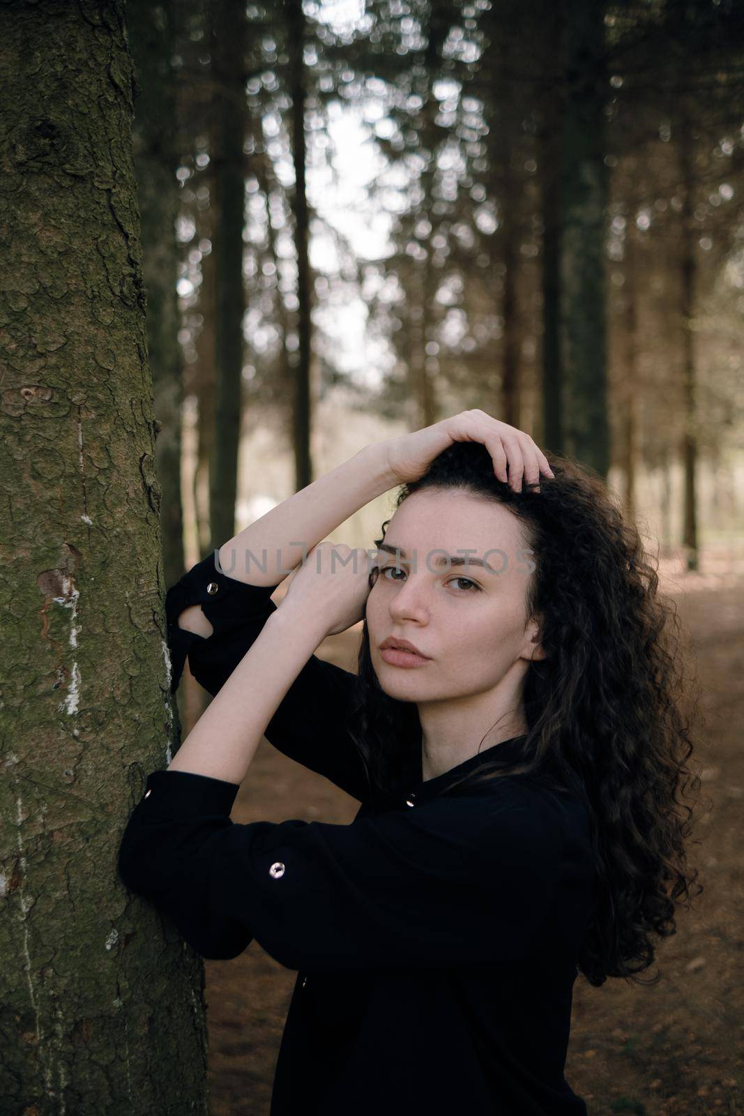 portrait of curly brunette womanin the park by Symonenko