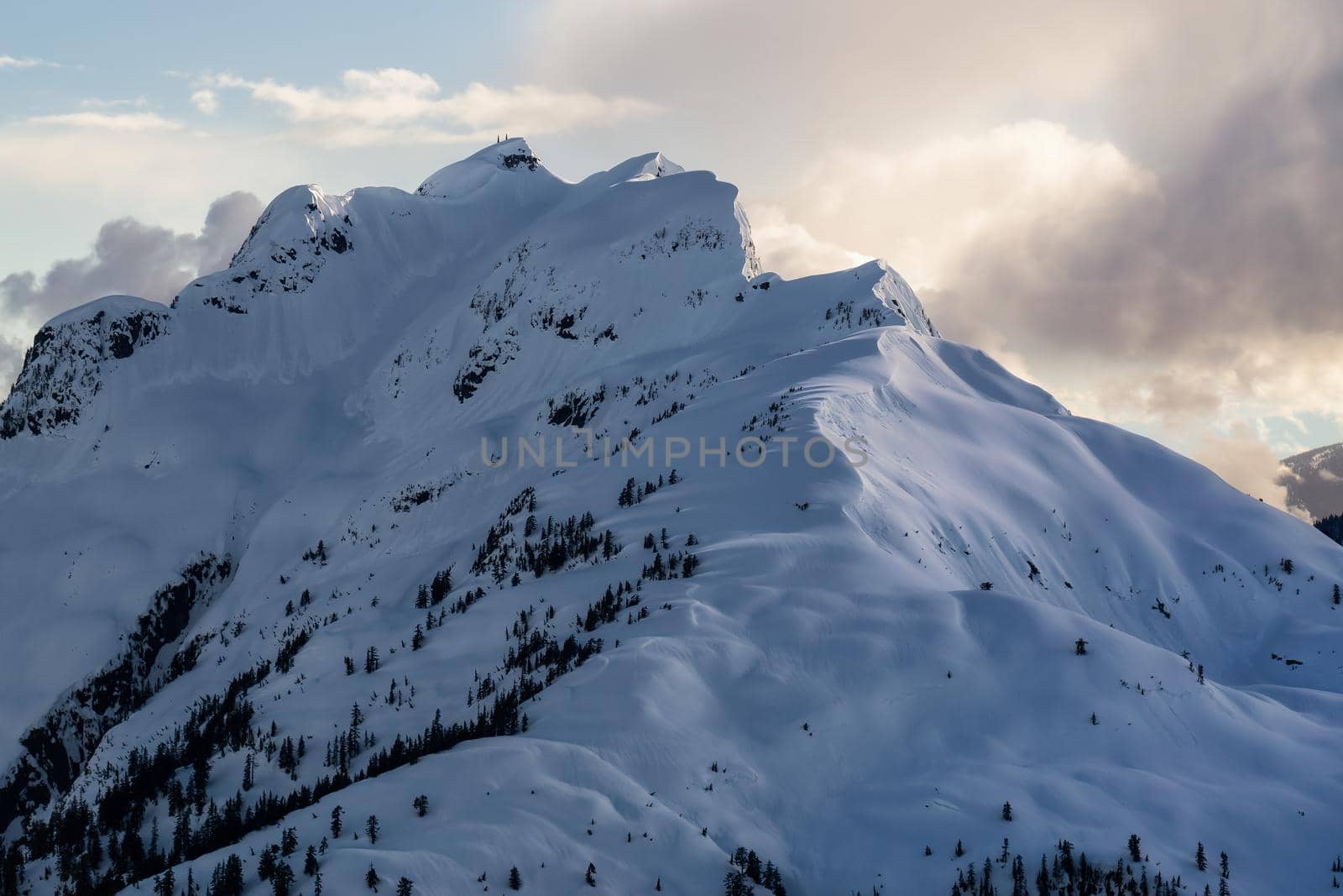 Aerial landscape view of the snow covered mountain range (Cathedral Mountain) North of Vancouver, British Columbia, Canada.